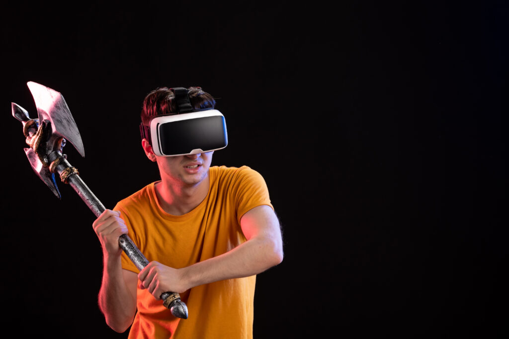 portrait-young-man-playing-vr-with-battle-axe-dark-wall